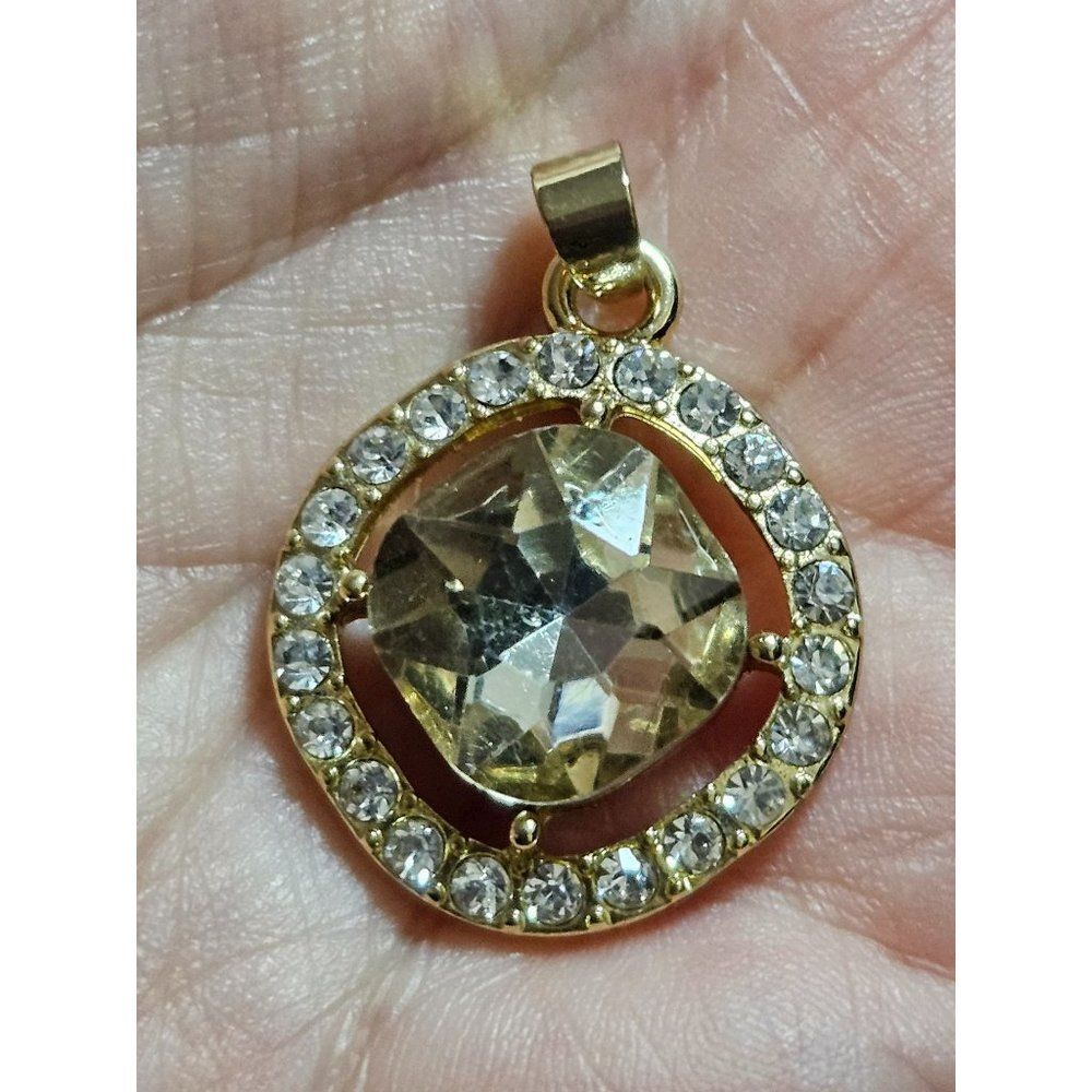 Gold tone champagne colored rhinestone pendant